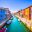 Venice landmark, Burano island canal, colorful houses and boats,