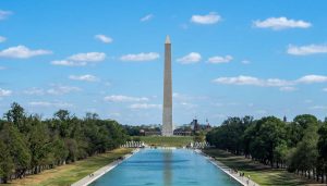 Washington Monument reflected in the lake at sunrise—an iconic scene often explored on Washington DC school trips highlighting national identity and symbolism.