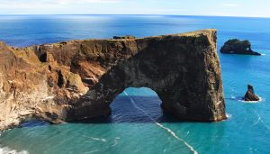 Dyrhólaey sea arch on Iceland’s south coast, a dramatic natural rock formation formed by marine erosion — a striking geographical feature ideal for school trips exploring coastal processes and landform development.