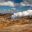 Tourists observe steaming geothermal vents at Hverir geothermal area in North Iceland — a key site for educational school tours exploring volcanic landscapes and geothermal energy.