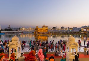 Tourists and worshipper walking inside the Golden Temple complex