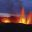 Active volcanic eruption at night with glowing lava fountains – perfect visual for geography school trips focusing on tectonic activity and natural hazards.