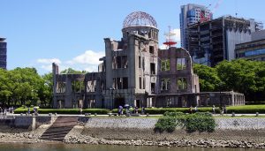 Students visiting the Hiroshima Peace Memorial (Atomic Bomb Dome) in Japan during an educational school trip focused on World War II history.
