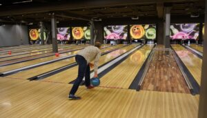 Student enjoying a bowling activity during an Iceland school trip, combining cultural exploration with leisure time on an educational travel program.
